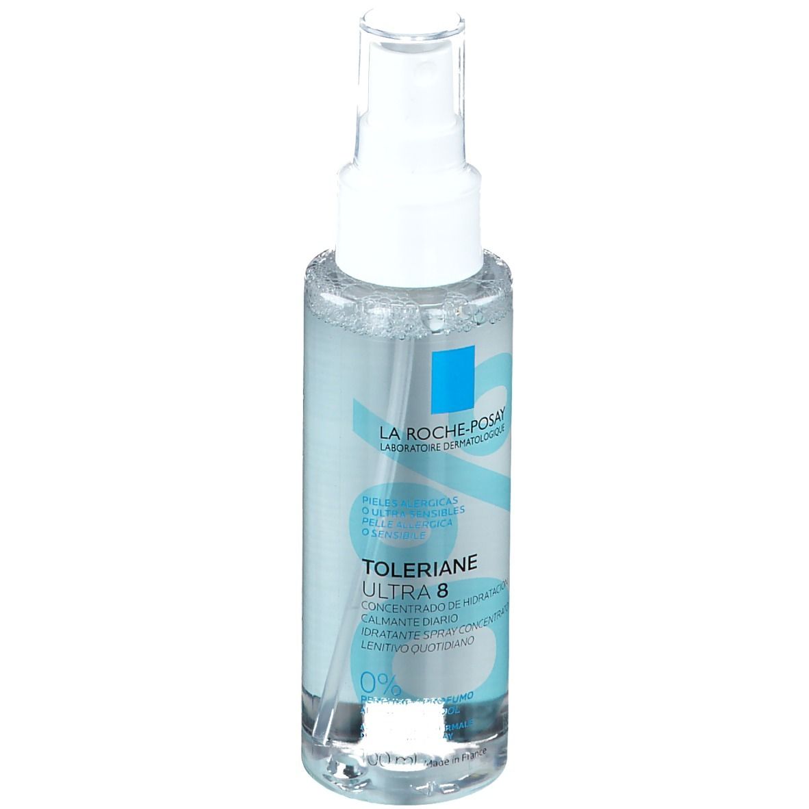 Flacone spray trasparente con erogatore bianco. Etichette blu con nome prodotto e logo. Testo: Toleriane Ultra 8, 0% profumo.