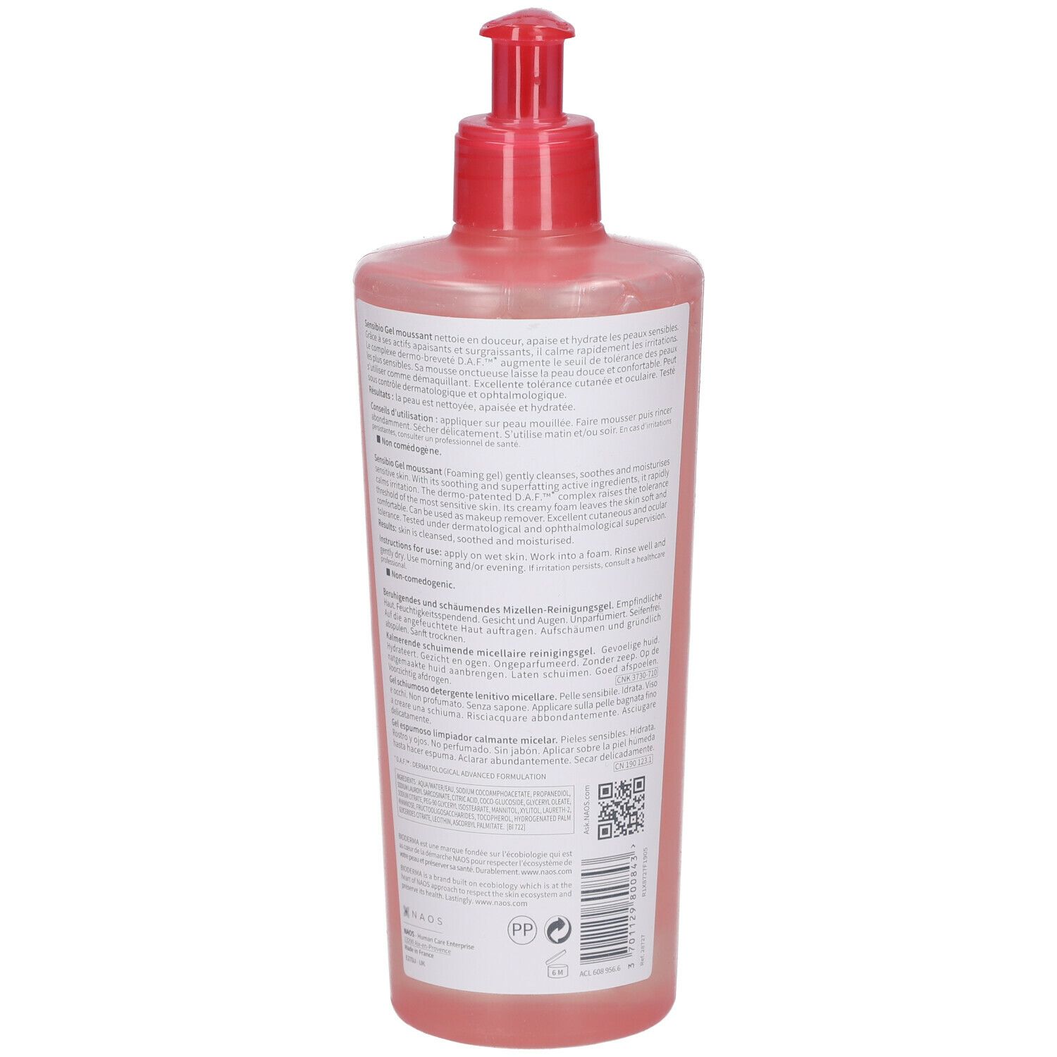 Vista posteriore di un flacone rosa con dosatore rosso. Testo multilingue. Codice QR.