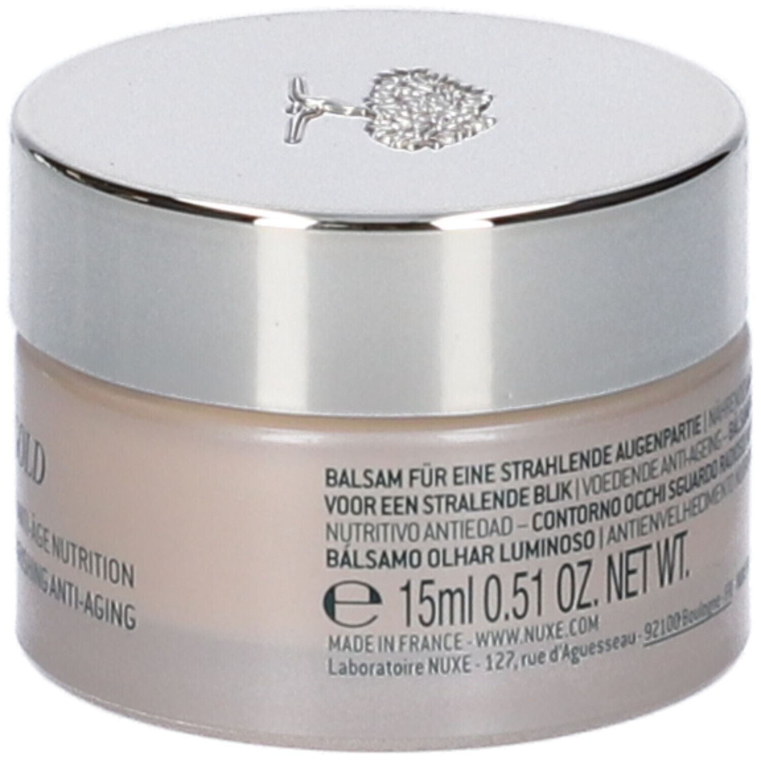 Vasetto di crema con coperchio argentato. NUXE, Nuxuriance Gold e testo multilingue sul vasetto.