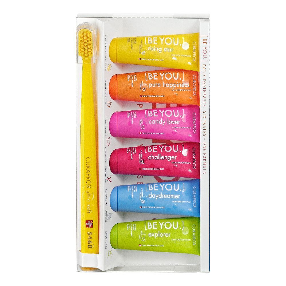 Spazzolino e sei tubetti di dentifricio colorati. Ogni tubetto riporta la scritta "BE YOU".