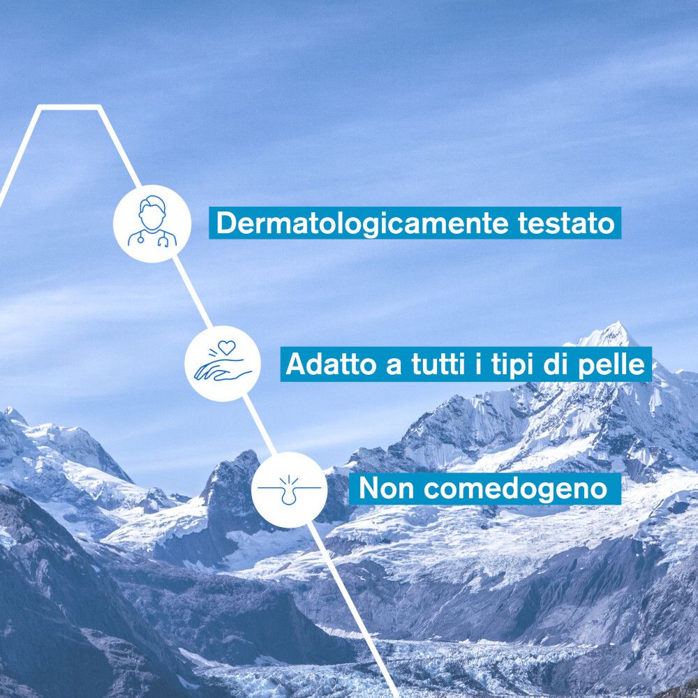 Dermatologicamente testato. Adatto a tutti i tipi di pelle. Non comedogeno. Montagne sullo sfondo.