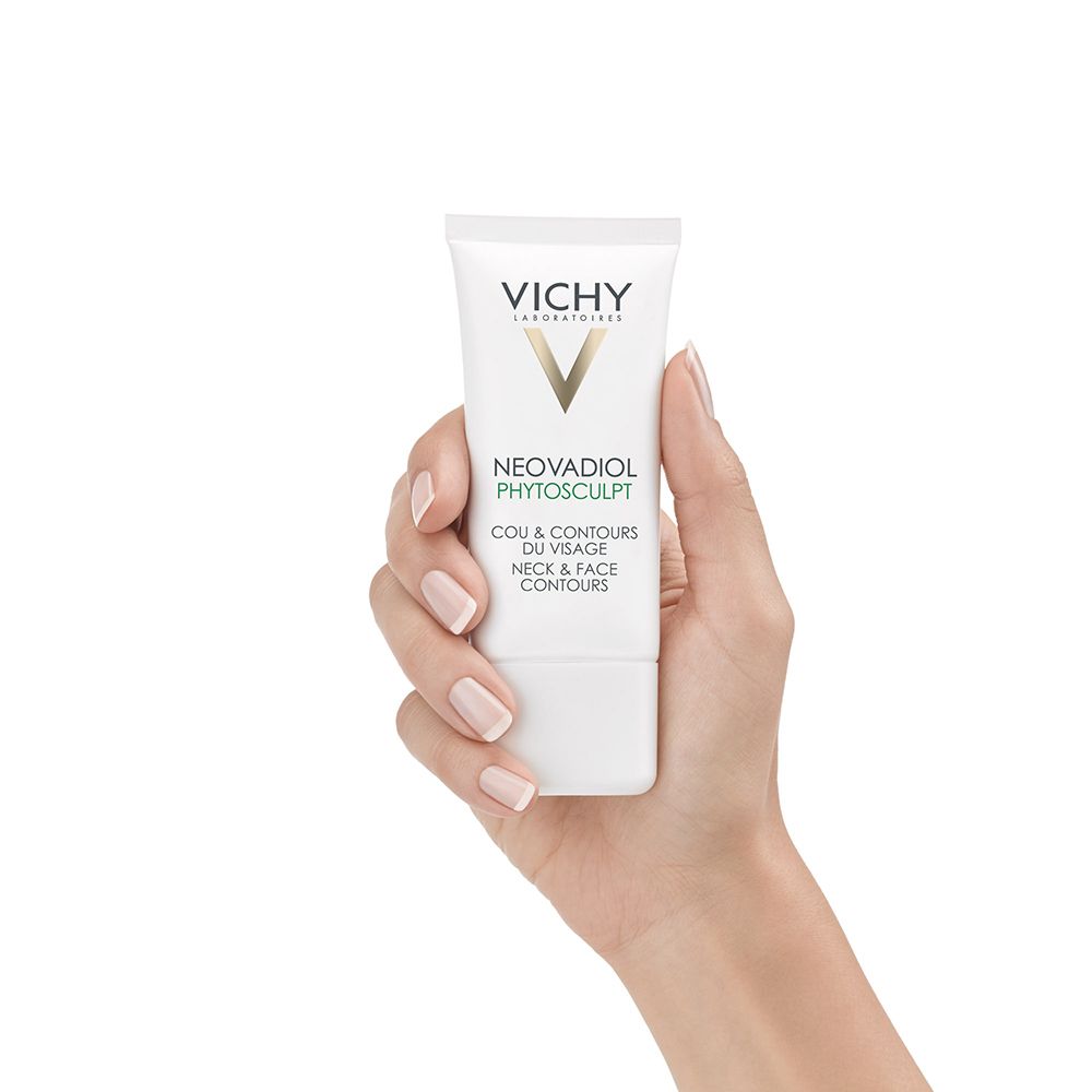 Mano che tiene un tubo bianco con logo VICHY e NEOVADIOL Phytoskulptur. Testo: Cou & Contours du Visage Neck & Face Contours.