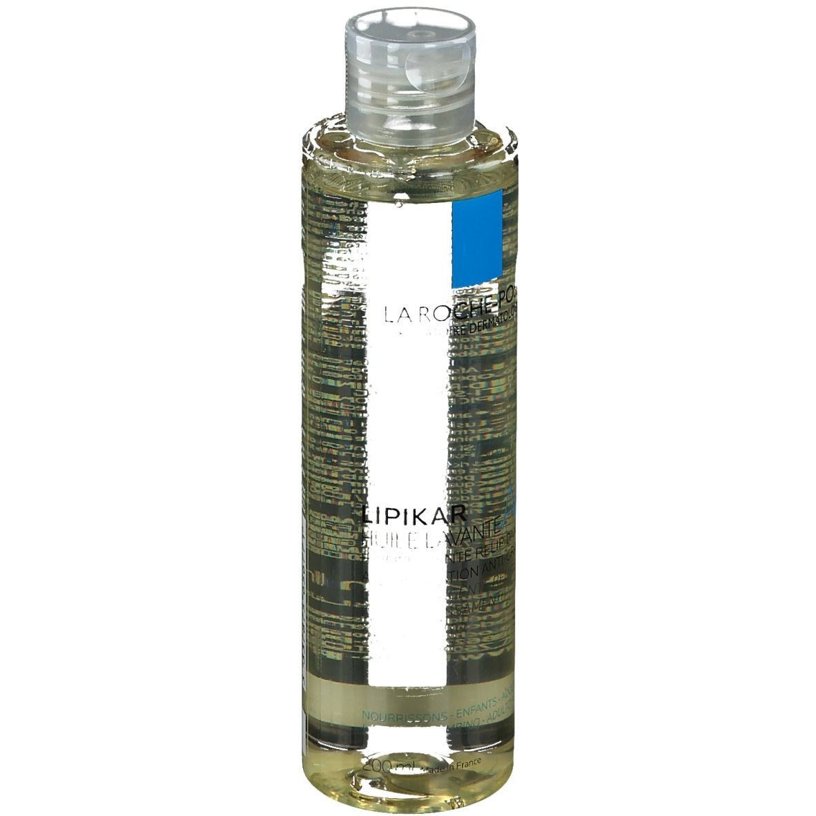 Olio detergente per il corpo in bottiglia con tappo trasparente. Etichetta con informazioni sul prodotto.
