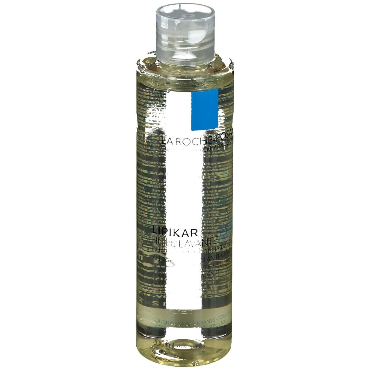 Olio detergente per il corpo in bottiglia con tappo trasparente. Etichetta con informazioni sul prodotto.