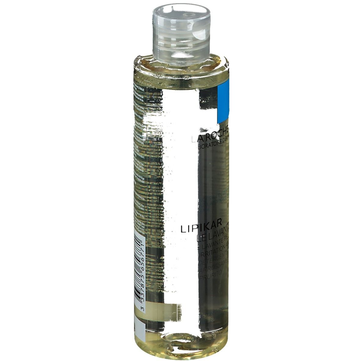 Olio detergente per il corpo in bottiglia con tappo trasparente. Etichetta con informazioni sul prodotto.
