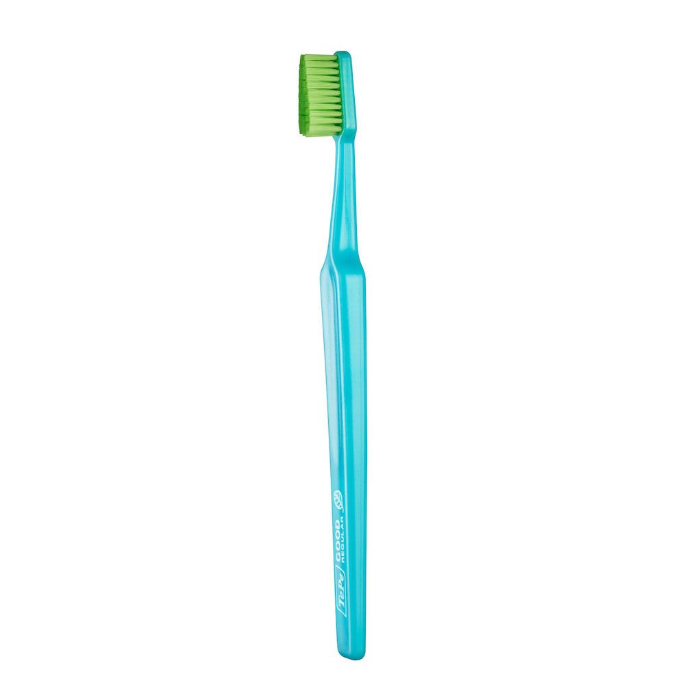 Spazzolino con manico blu e setole verdi. Scritta: GOOD.