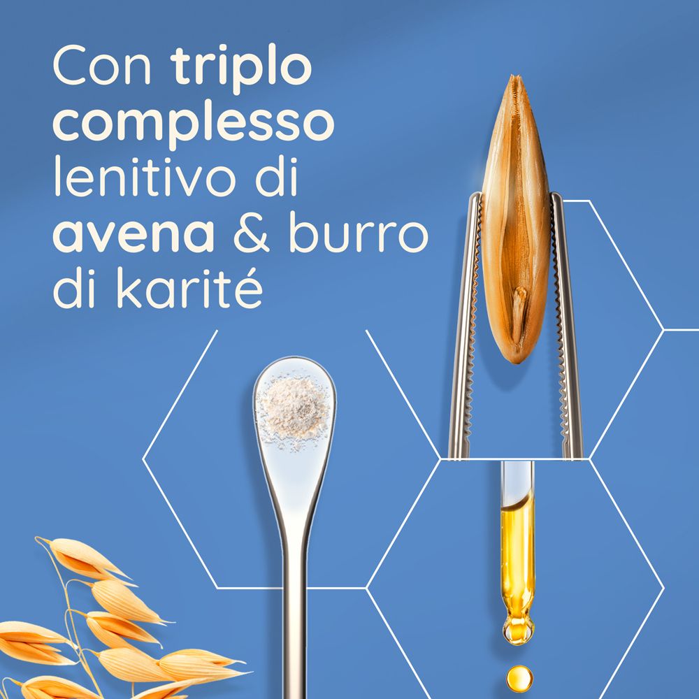 Primo piano di avena e burro di karité. Testo: Con triplo complesso lenitivo di avena & burro di karité.