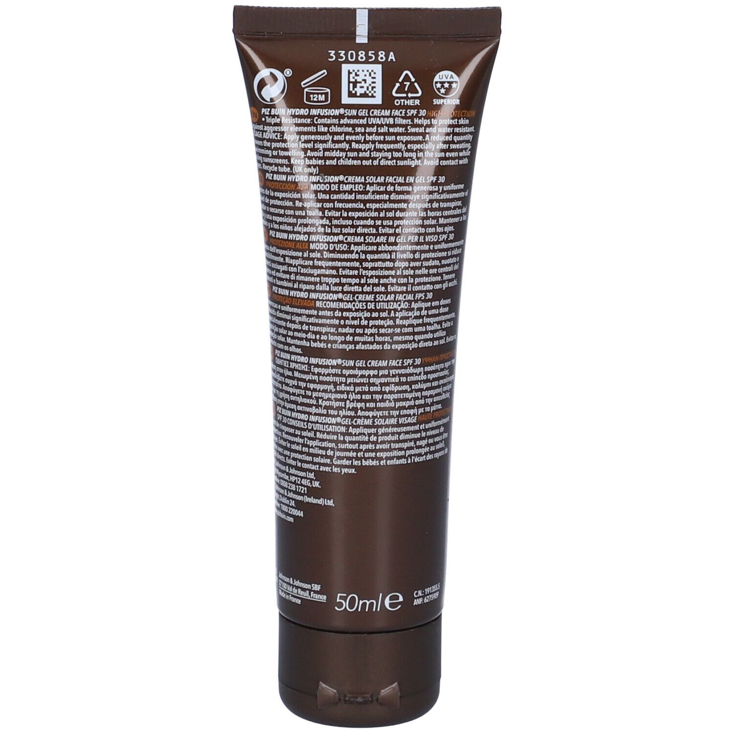 Retro del tubo. Testo multilingue. Contiene informazioni sugli ingredienti e l'uso. Tubo marrone con tappo nero.