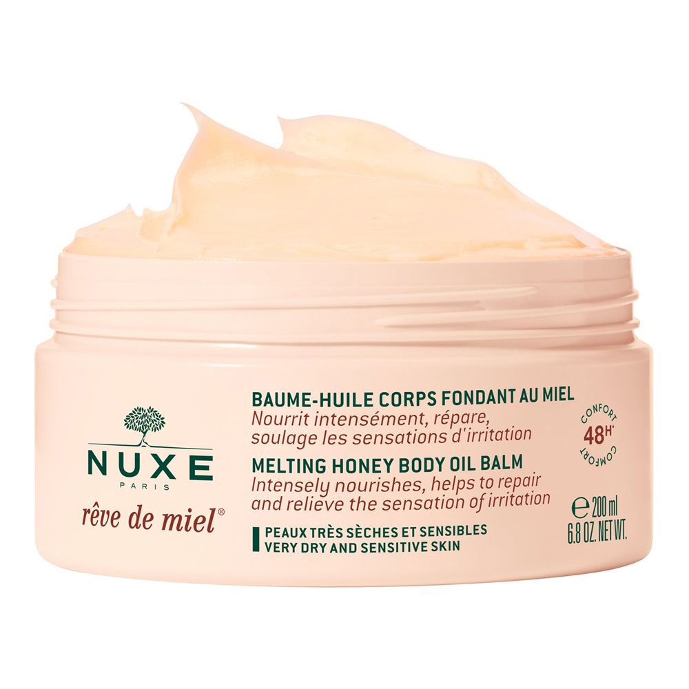 Barattolo di crema aperto con coperchio marrone. Sostanza cremosa giallastra. Scritta: NUXE Rêve de Miel, Melting Honey Body Oil Balm.