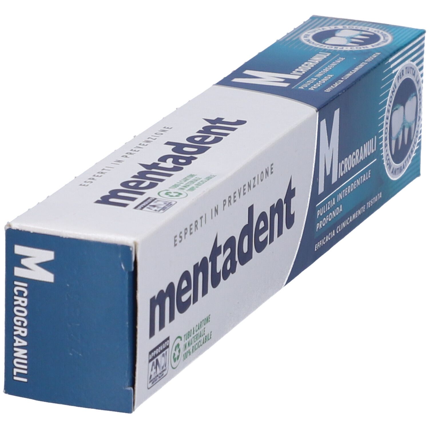 Zahncreme-Verpackung, schräg. Weiß und blau, mit 'mentadent' und 'Microgranuli'.