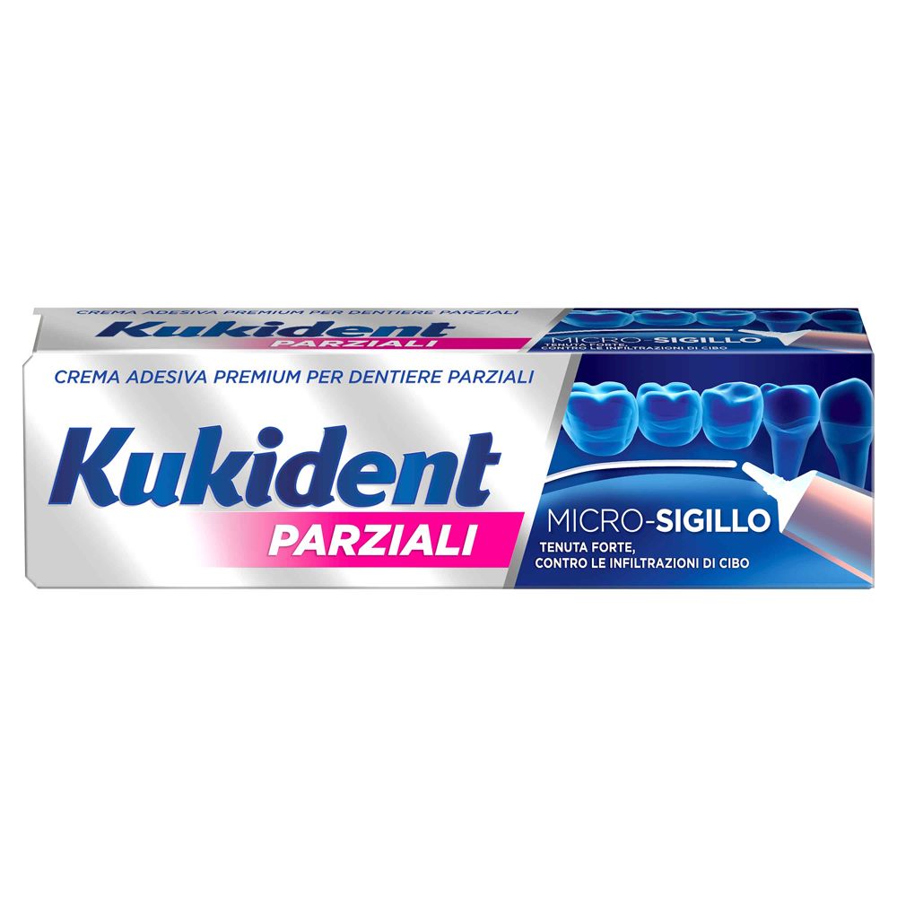 Tubo di crema adesiva per dentiere parziali. Marchio e testo in italiano. Colori bianco e blu.