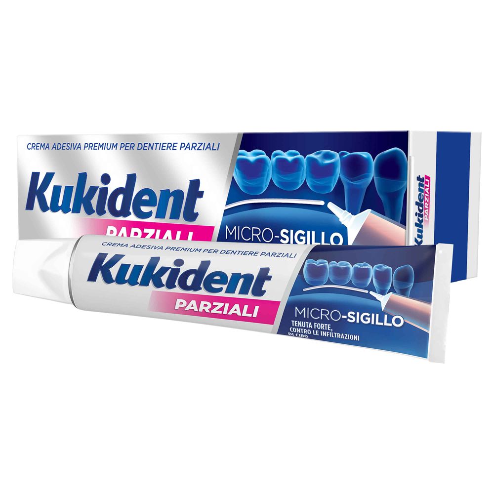 Tubo e scatola di crema adesiva per dentiere parziali. Marchio e testo in italiano. Blu e bianco.
