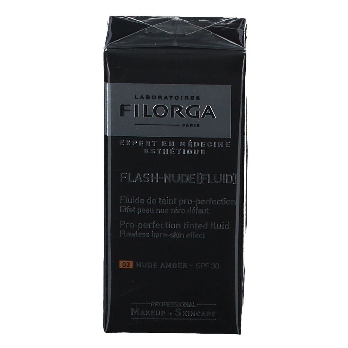 Schwarzer Karton mit FILORGA Make-up. Aufschrift: FLASH-NUDE [FLUID], NUDE AMBER, SPF 30. Verpackung.