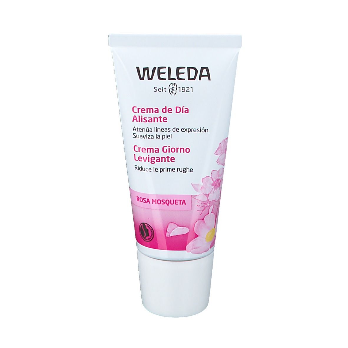 Tubo Weleda. Bianco con accenti rosa. Testo: Creme de Día Alisante, Creme Giorno Levigante, Rosa Mosqueta. Tappo bianco.