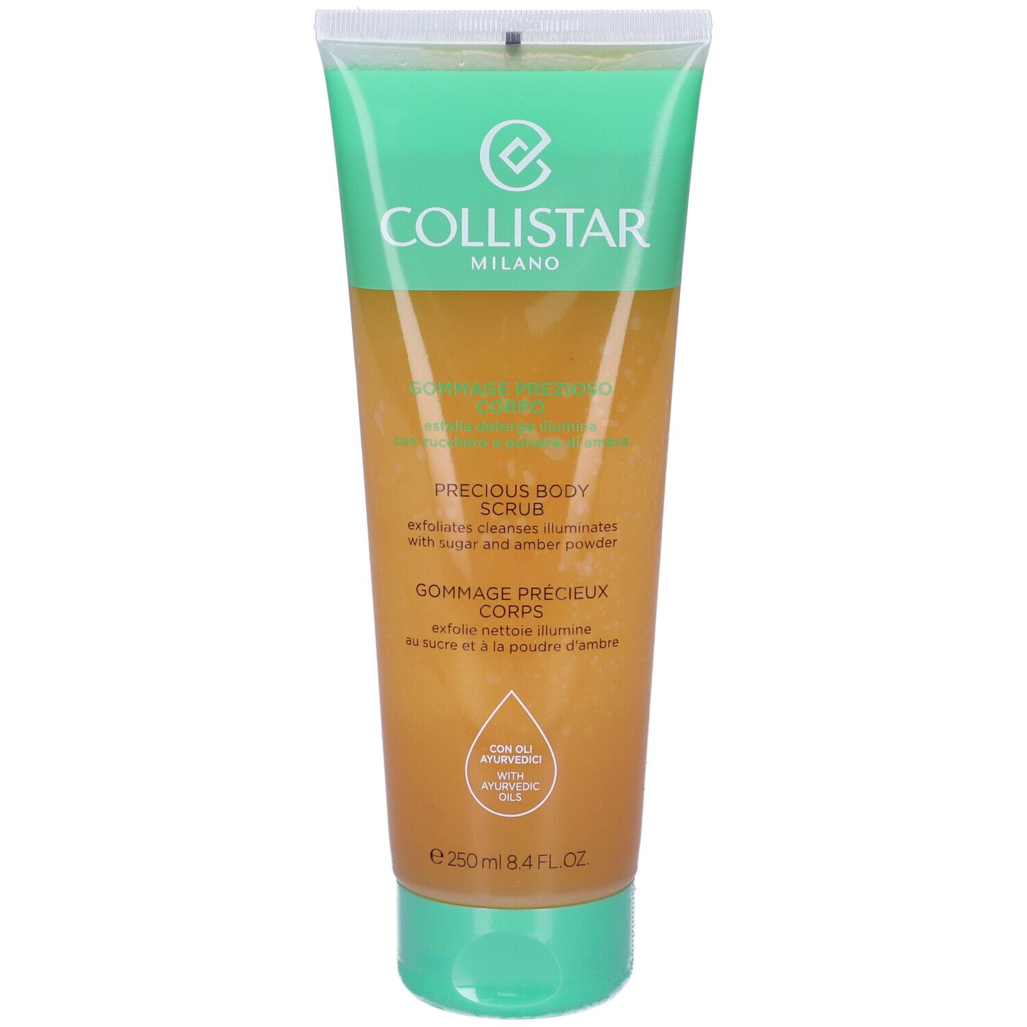 Tubo di gommage corpo con tappo verde. Scritta: PRECIOUS BODY SCRUB, GOMMAGE PRECIEUX CORPS. Con oli ayurvedici.