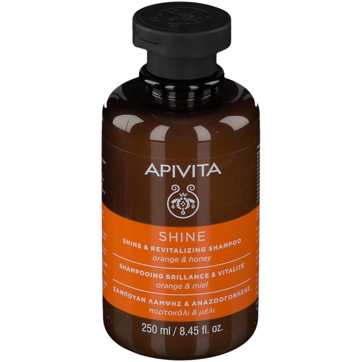 Flacone di shampoo marrone con tappo nero. Scritta: APIVITA SHINE Shampoo, Arancia e miele. 250 ml.