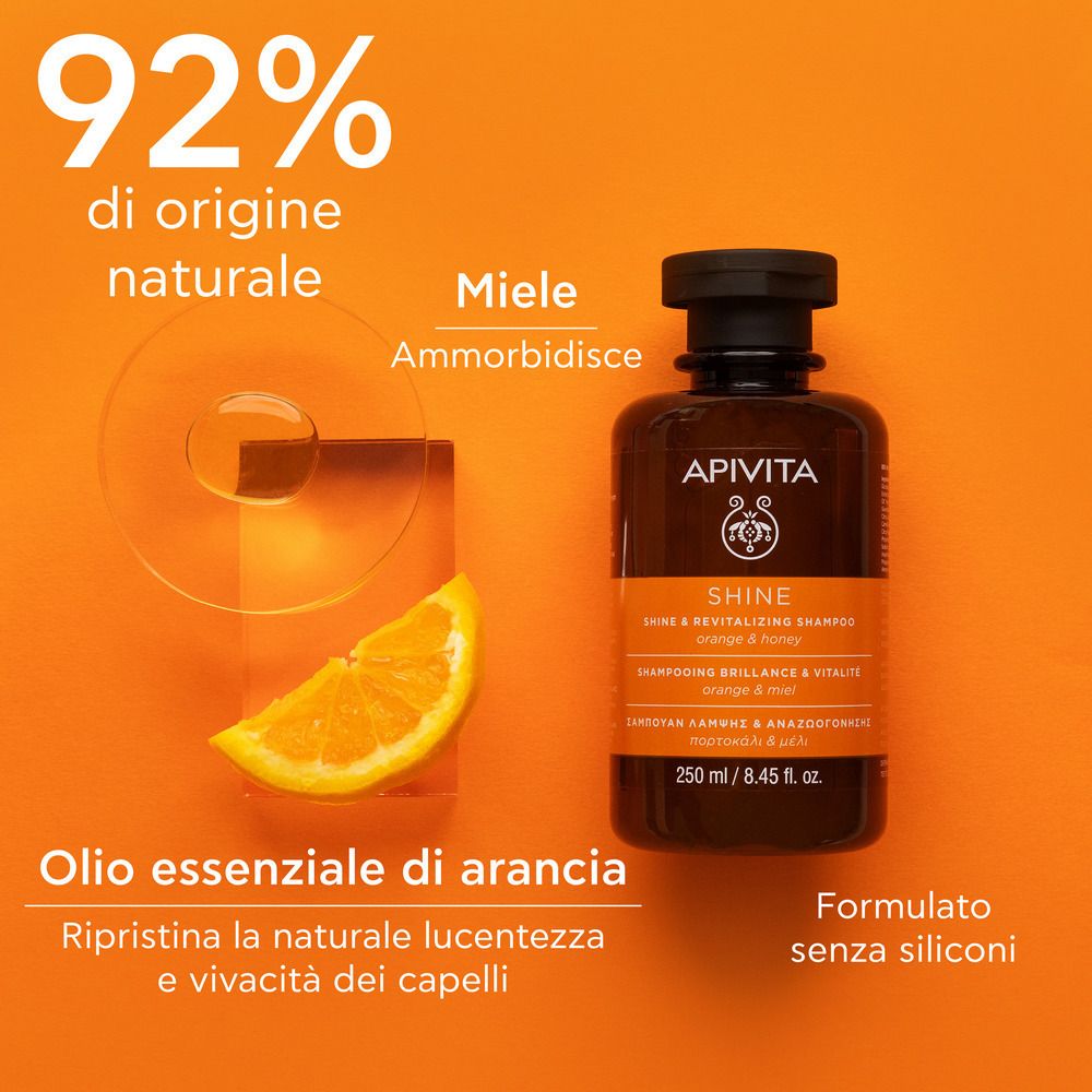 Flacone di shampoo con arancia e miele. Testo: 92% di origine naturale, miele, olio essenziale di arancia. Senza siliconi.