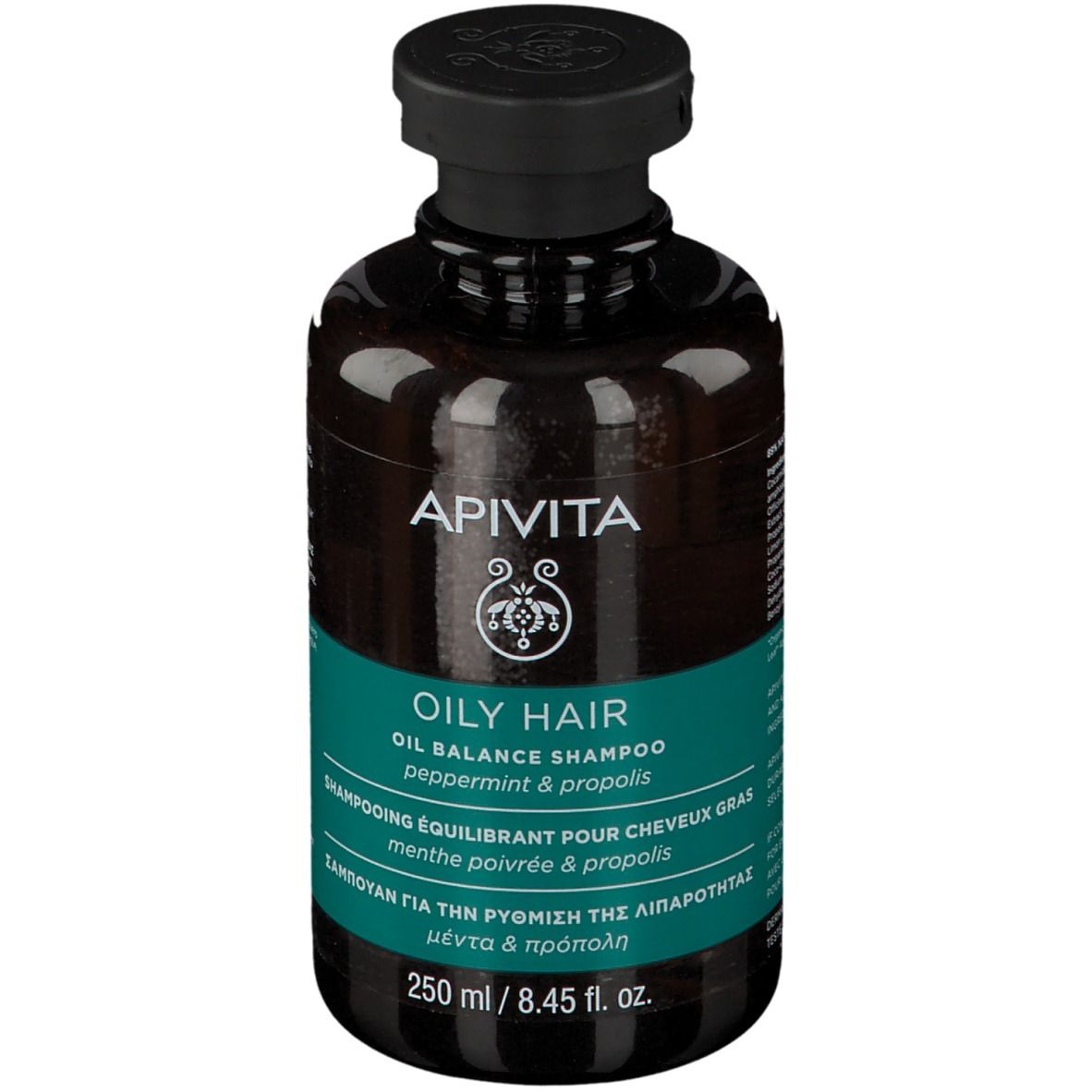 Flacon brun avec bouchon noir. Inscription : APIVITA, OILY HAIR, Oil Balance Shampoo. Étiquette turquoise.