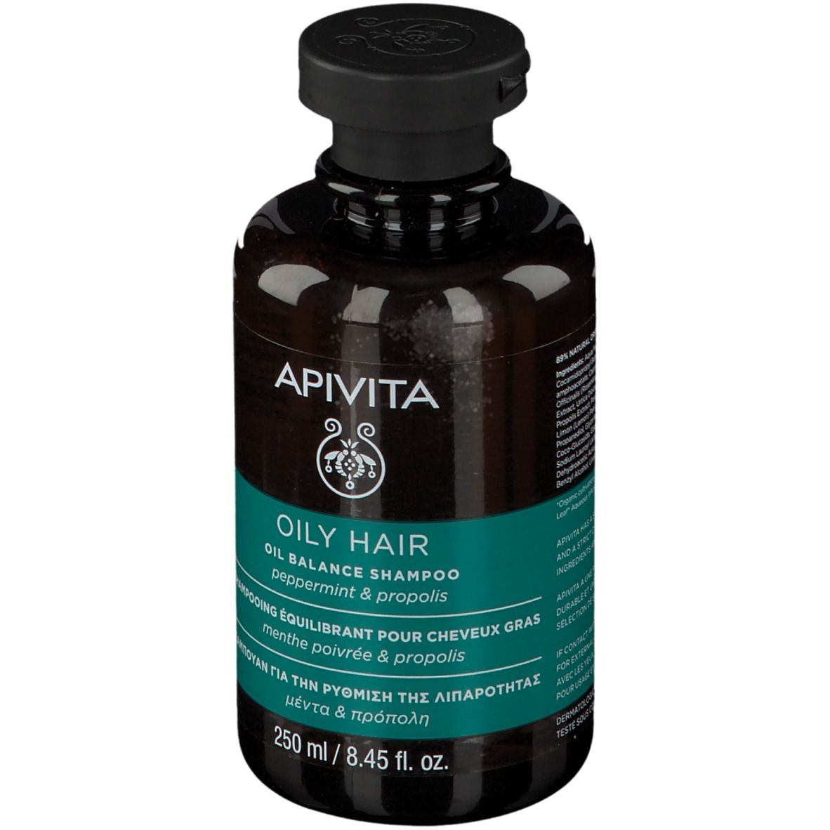 Flacon brun avec bouchon noir. Inscription : APIVITA, OILY HAIR, Oil Balance Shampoo. Étiquette turquoise.