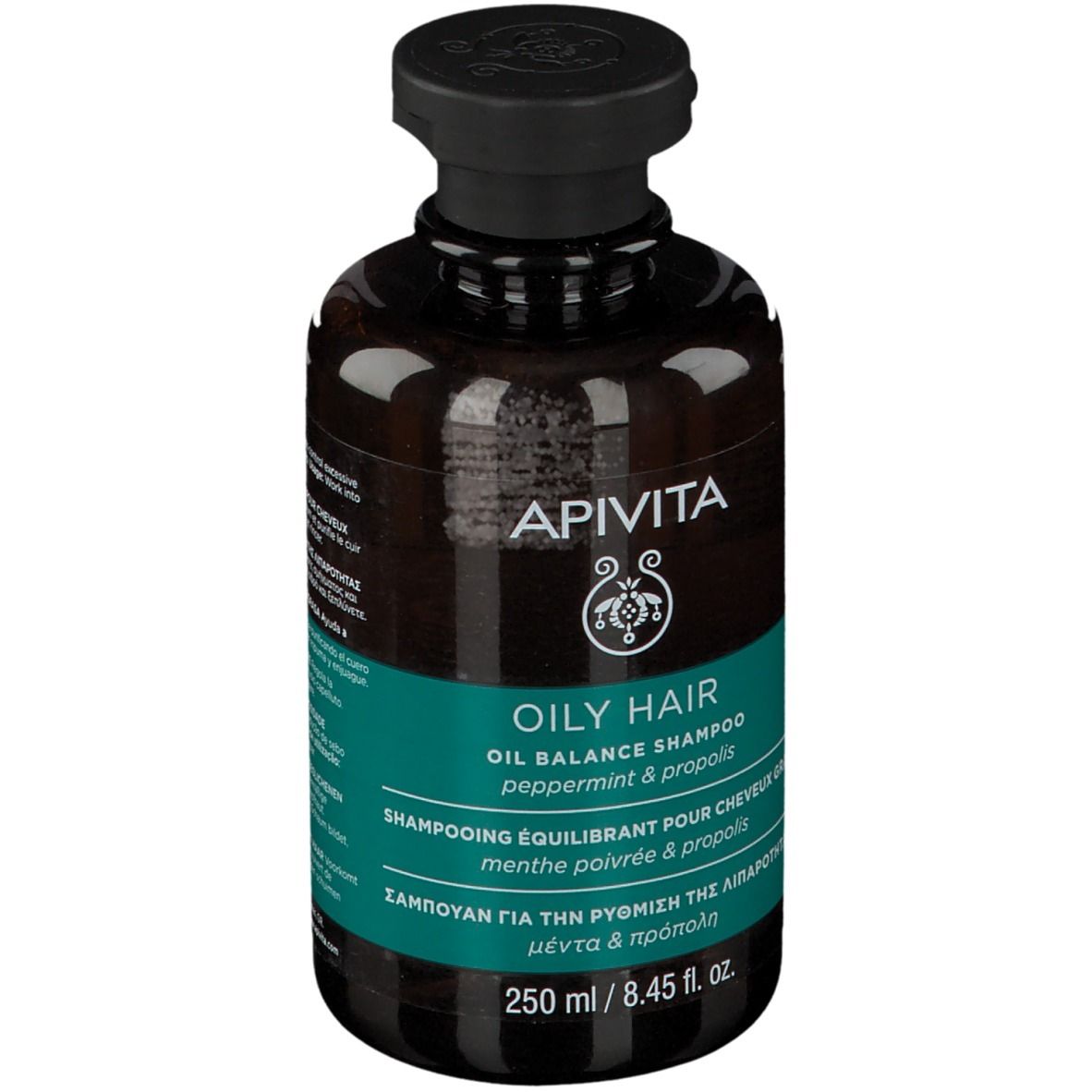 Flacon brun avec bouchon noir. Inscription : APIVITA, OILY HAIR, Oil Balance Shampoo. Étiquette turquoise.