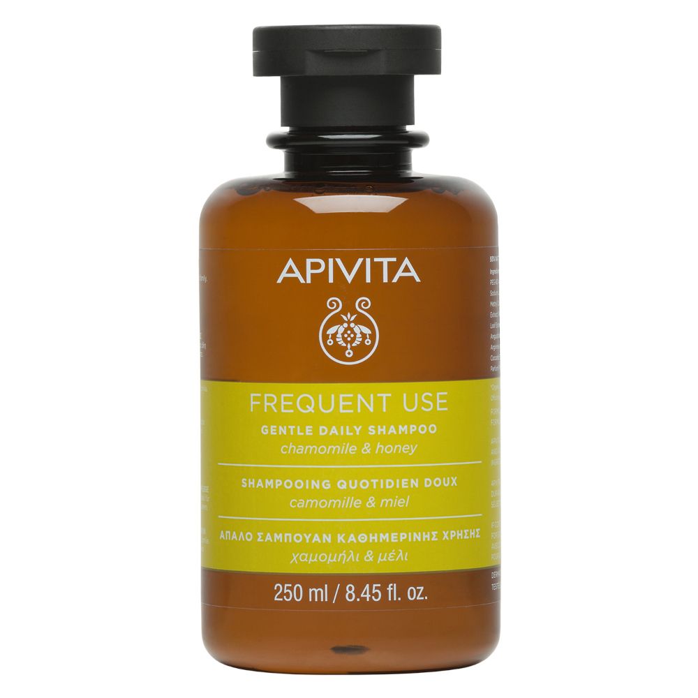 Flacone di shampoo marrone con tappo nero. Etichetta gialla con testo. Marchio: APIVITA.