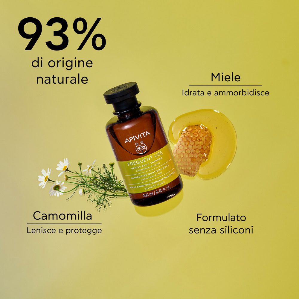 Flacone di shampoo con testo e illustrazioni. Testo: 93% di origine naturale. Camomilla, miele.