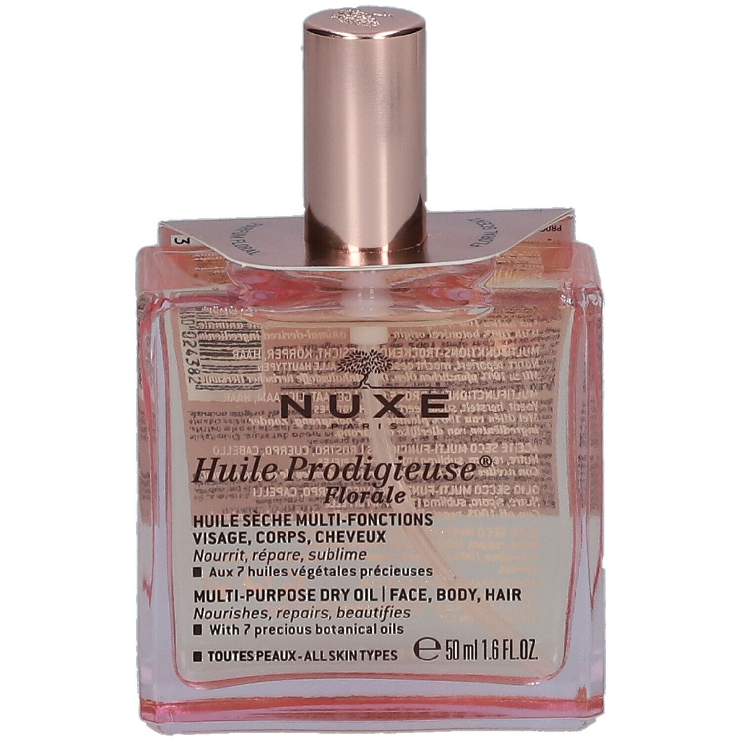 Flacone quadrato in vetro con olio rosato. Scritta: Nuxe Huile Prodigieuse Florale. Tappo rosa.
