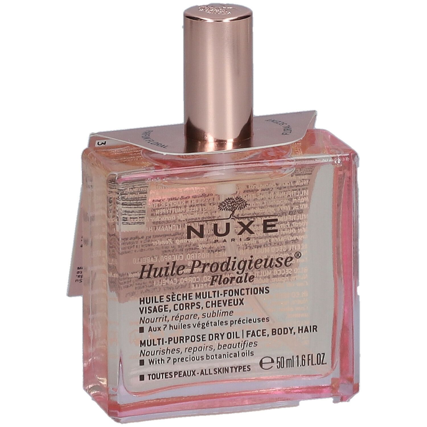 Flacone in vetro con olio rosato. Scritta: Nuxe Huile Prodigieuse Florale. Tappo rosa. Etichetta.