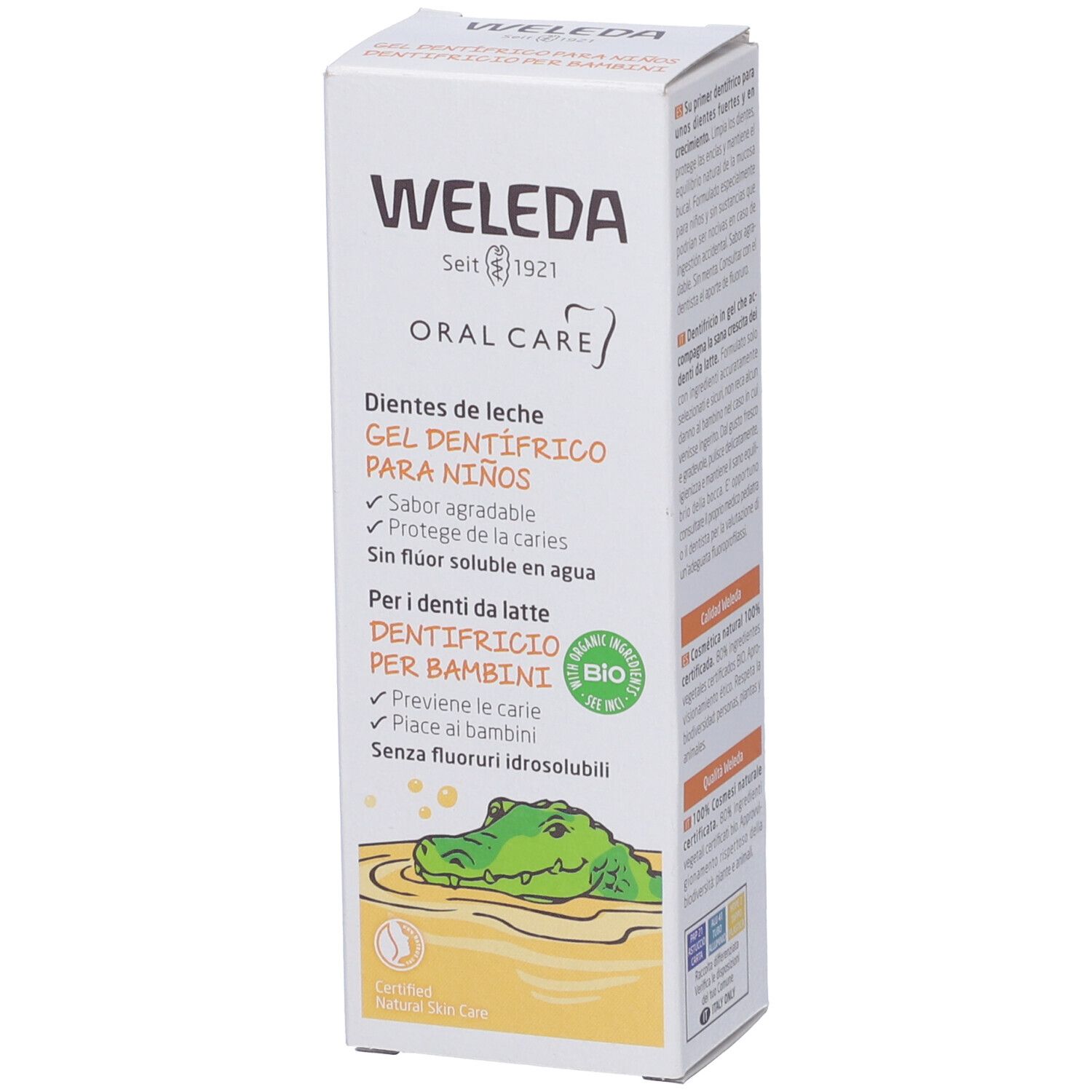 Confezione di gel dentifricio Weleda. Testo: "Oral Care", "Gel dentifrico para niños". Certificazione bio. Illustrazione di un coccodrillo.