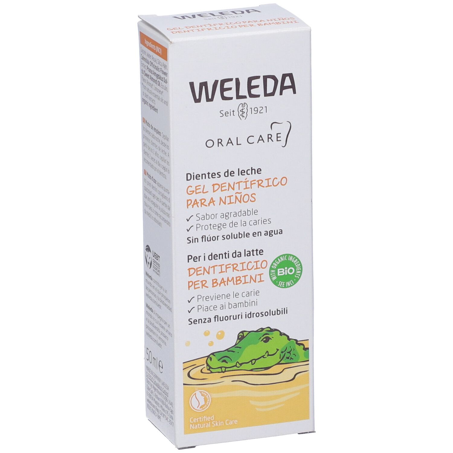 Confezione di gel dentifricio Weleda. Testo: "Oral Care", "Gel dentifrico para niños". Certificazione bio. 50ml. Illustrazione di un coccodrillo. Colori giallo e bianco.