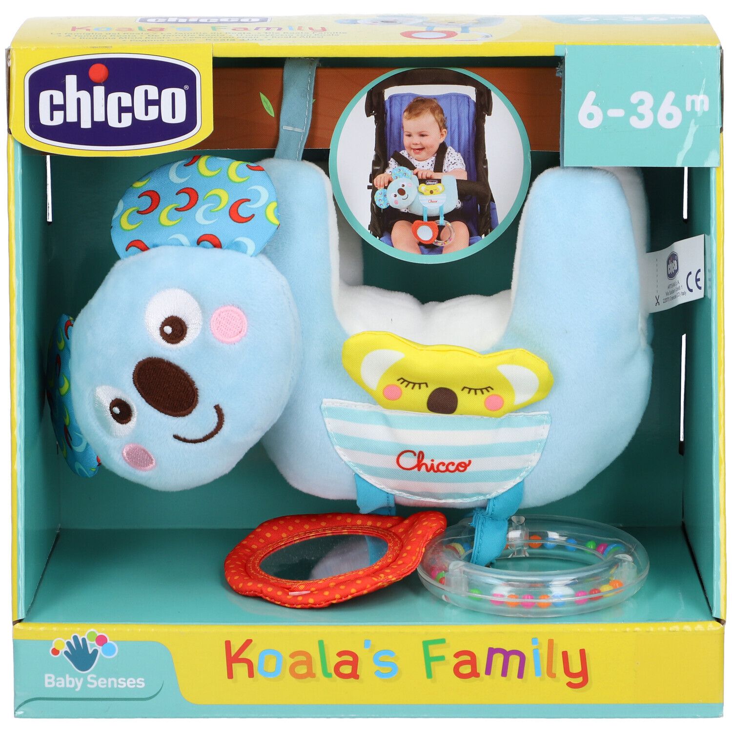 Giocattolo a forma di koala in confezione. Blu, con orecchie gialle e anello arancione. Logo e nome sulla confezione.