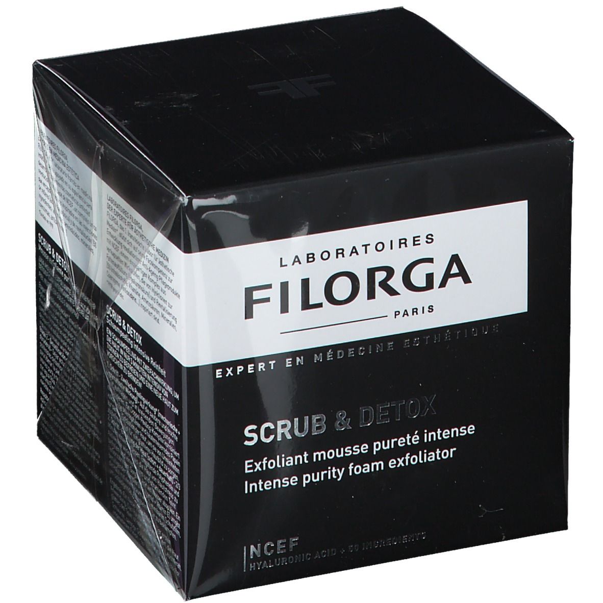 Boîte noire avec informations sur le produit. Inscription FILORGA SCRUB & DETOX. Texte: Exfoliant mousse pureté intense, Intense purity foam exfoliator.