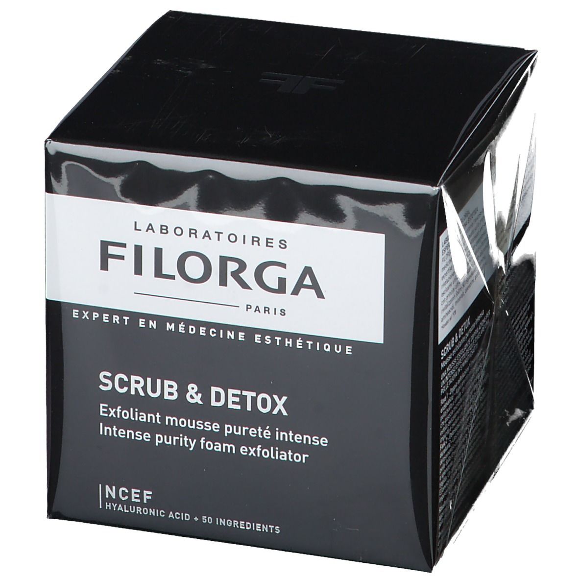 Boîte noire avec étiquette blanche. Inscription FILORGA SCRUB & DETOX. Texte: Exfoliant mousse pureté intense, Intense purity foam exfoliator.