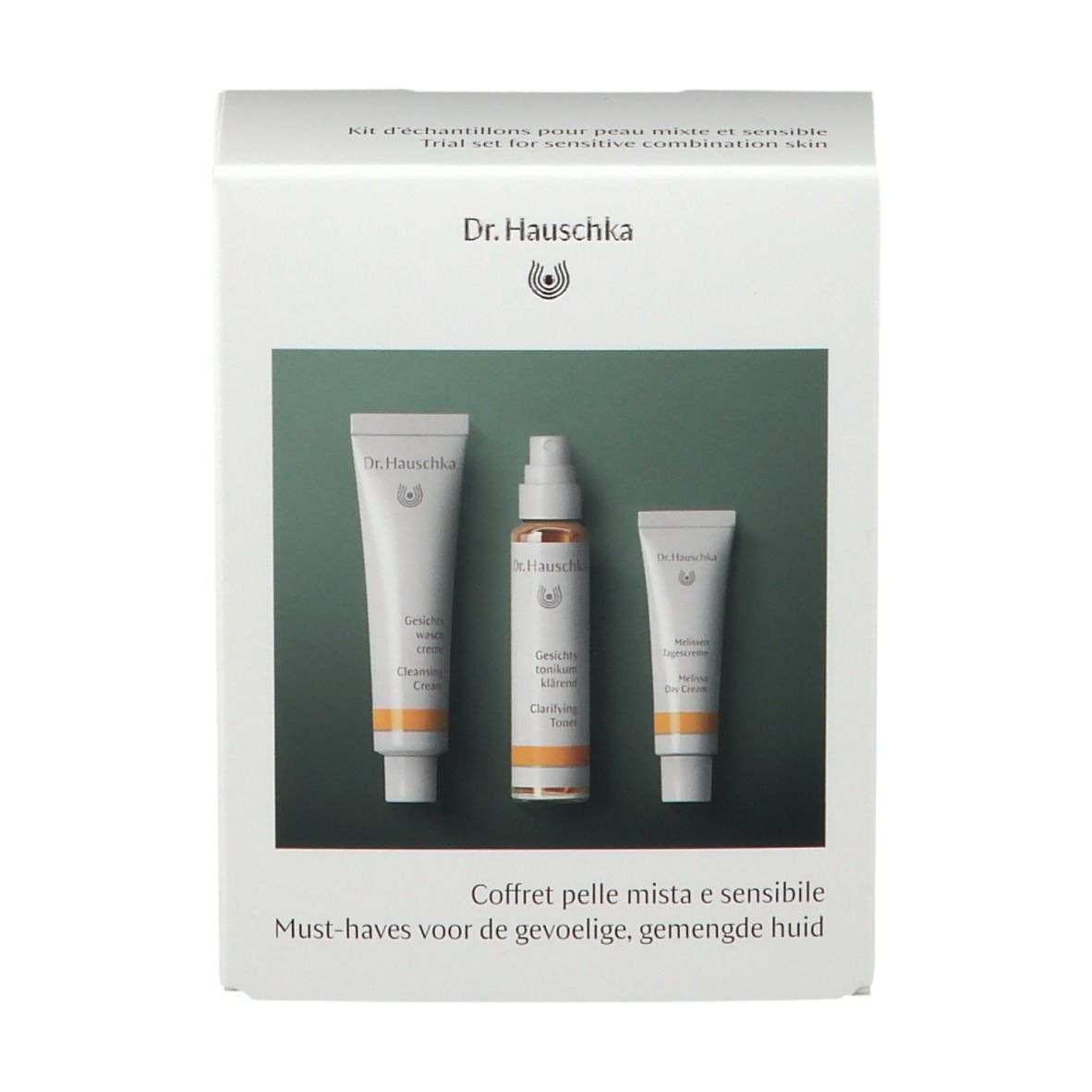 Scatola bianca con tre prodotti. Scritto: Dr. Hauschka. Testo multilingue.