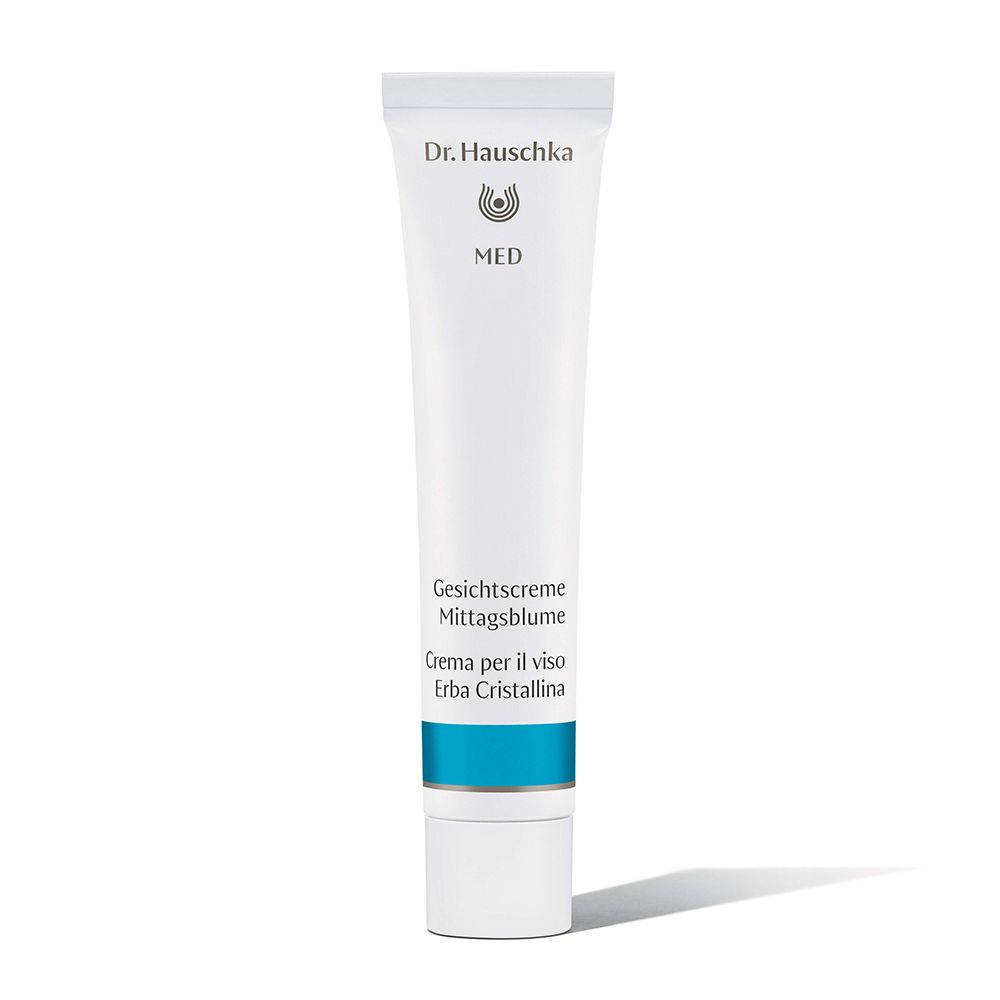 Weiße Tube mit blauer Banderole. Schriftzug: Dr. Hauschka MED, Gesichtscreme Mittagsblume, Creme per il viso Erba Cristallina.