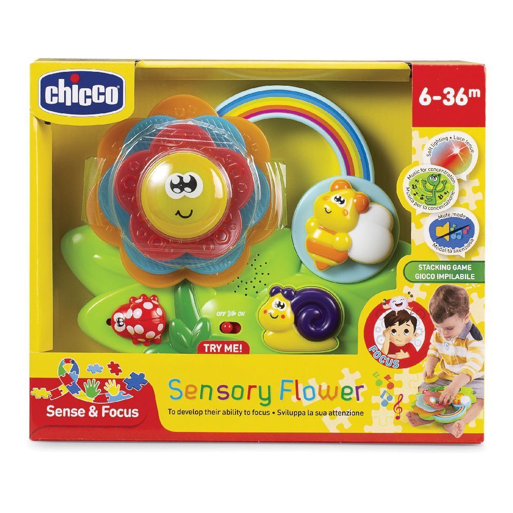 Giocattolo sensoriale con motivi floreali e insetti. Include un fiore, un arcobaleno e una lumaca. Confezionato in una scatola gialla con il logo Chicco.