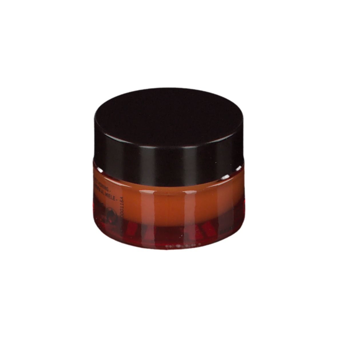 Vasetto rotondo con balsamo marrone e coperchio nero. Testo sul retro visibile.