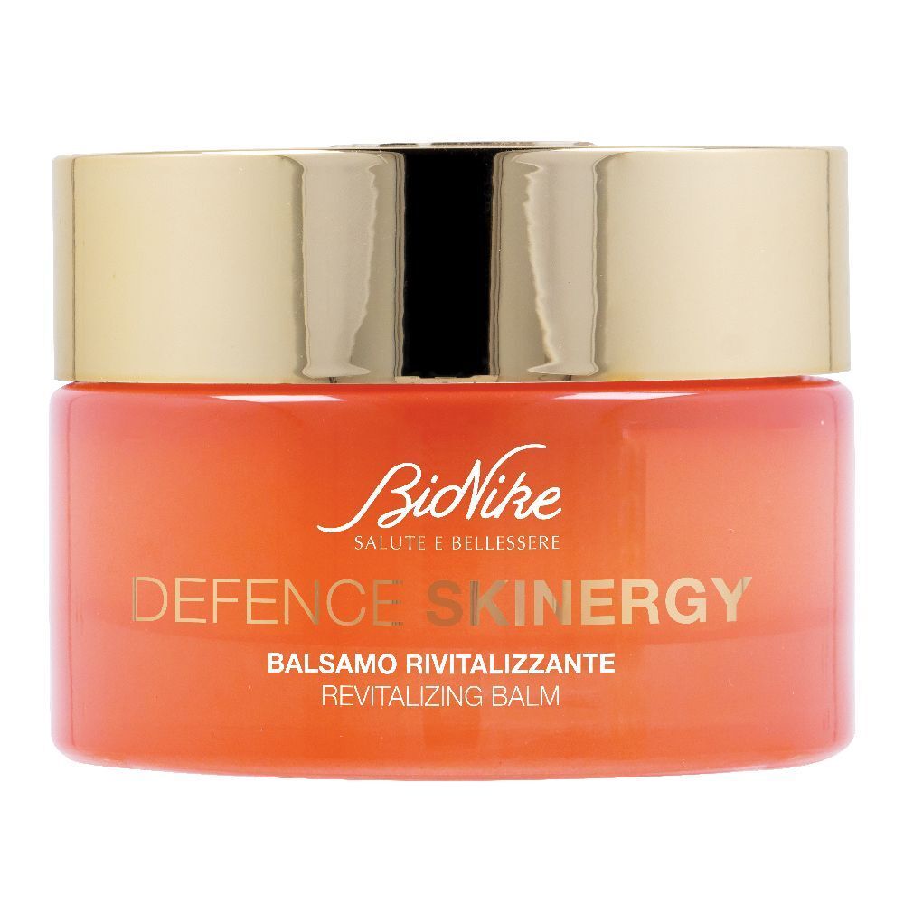 Vaso di crema con coperchio dorato. Scritta: Defence Skinergy, Balsamo Rivitalizzante. Vaso arancione.