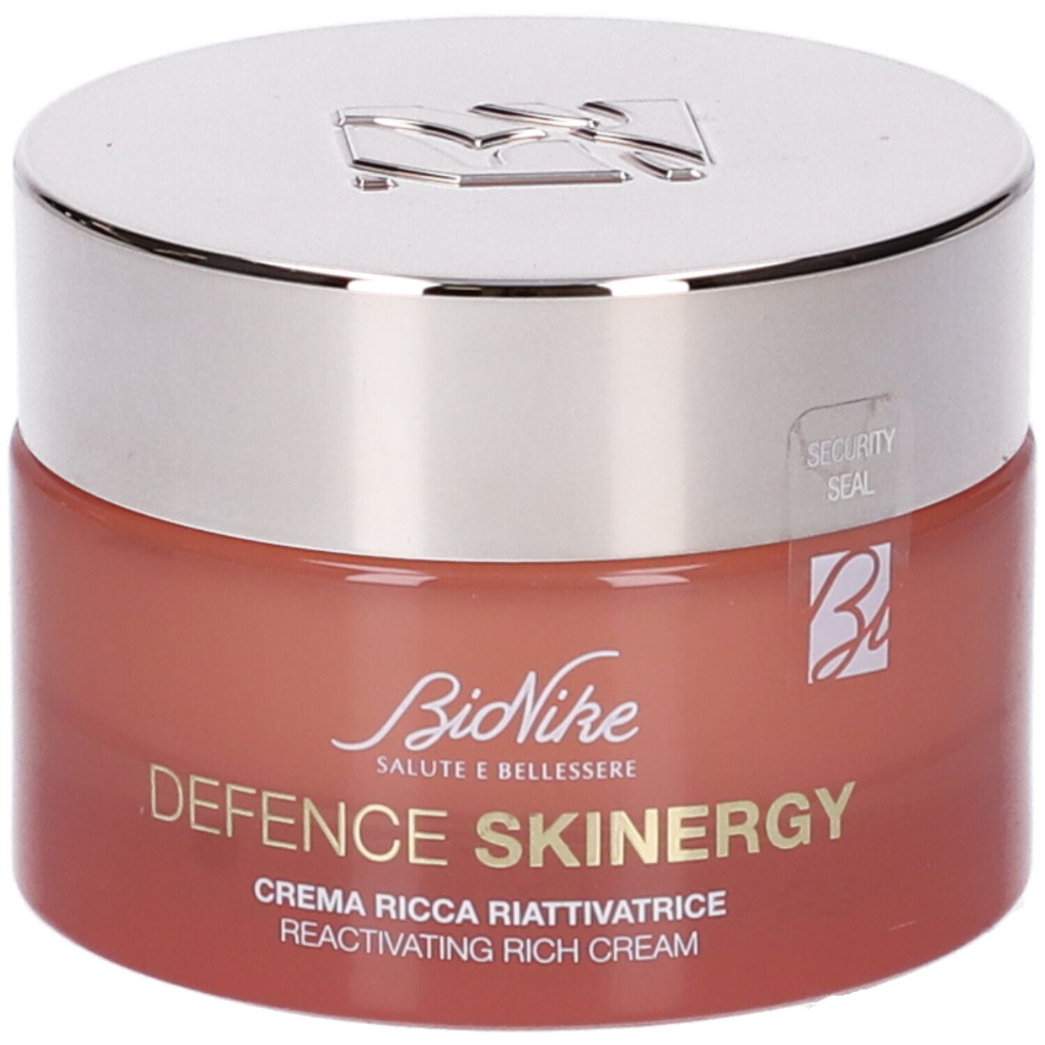 Vaso di crema con coperchio argentato. Scritta: Defence Skinergy, Crema Ricca Riattivatrice. Vaso rosso.