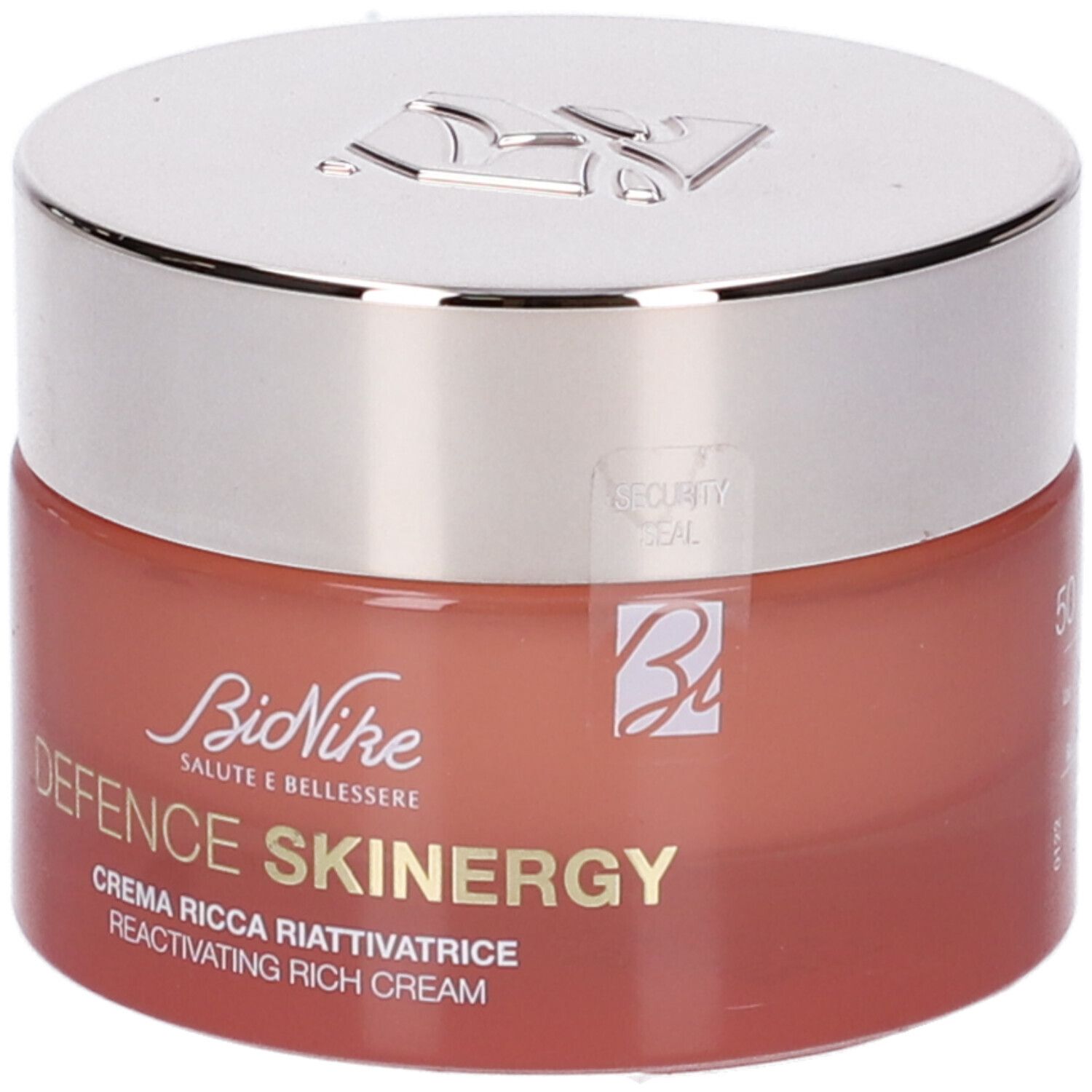 Vaso di crema con coperchio argentato. Scritta: Defence Skinergy, Crema Ricca Riattivatrice. Vaso rosso.