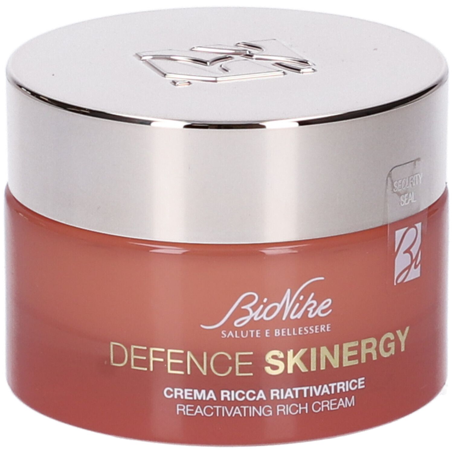 Vaso di crema con coperchio argentato. Scritta: Defence Skinergy, Crema Ricca Riattivatrice. Vaso rosso.