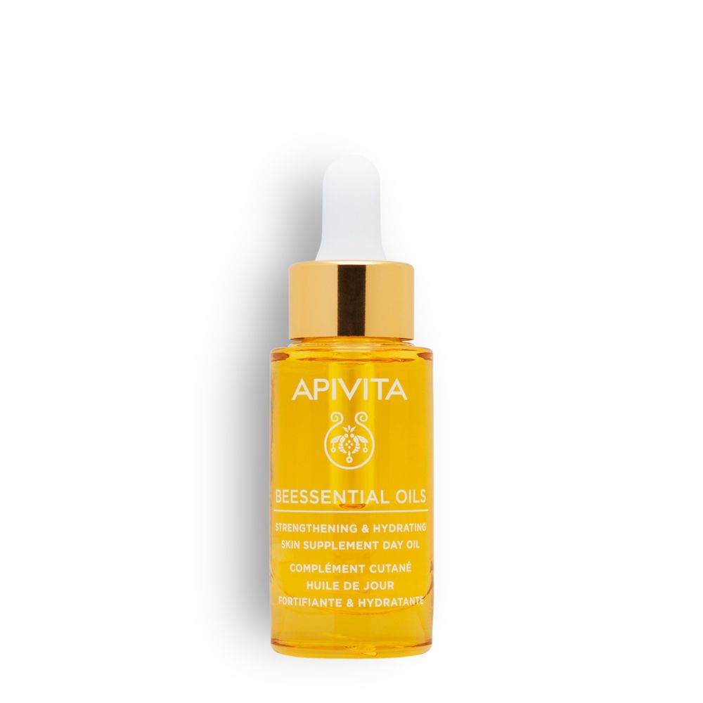 Olio trasparente in flacone di vetro con contagocce. Tappo dorato, punta bianca. Etichetta con testo.