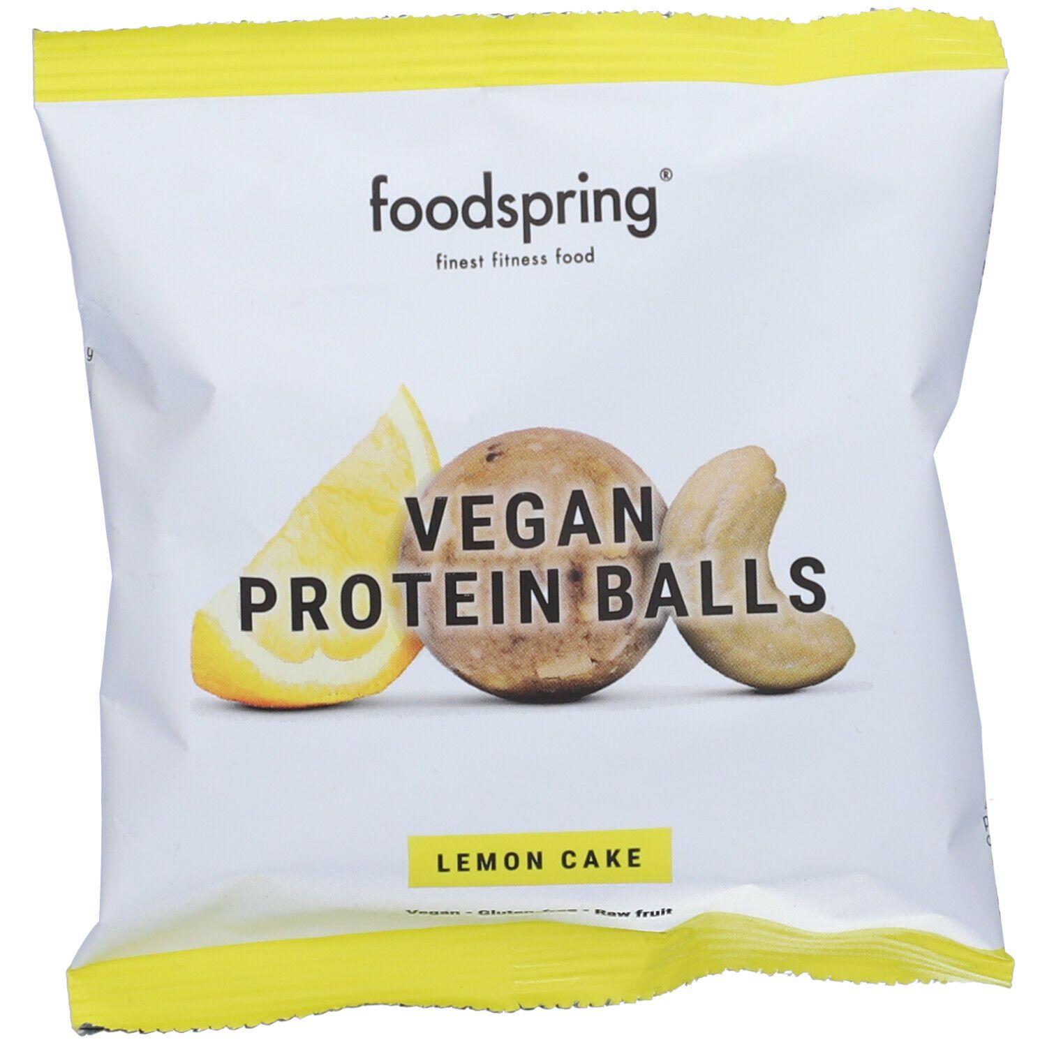 Confezione di Vegan Protein Balls Lemon Cake. Logo Foodspring. Limone, anacardi e pallina.