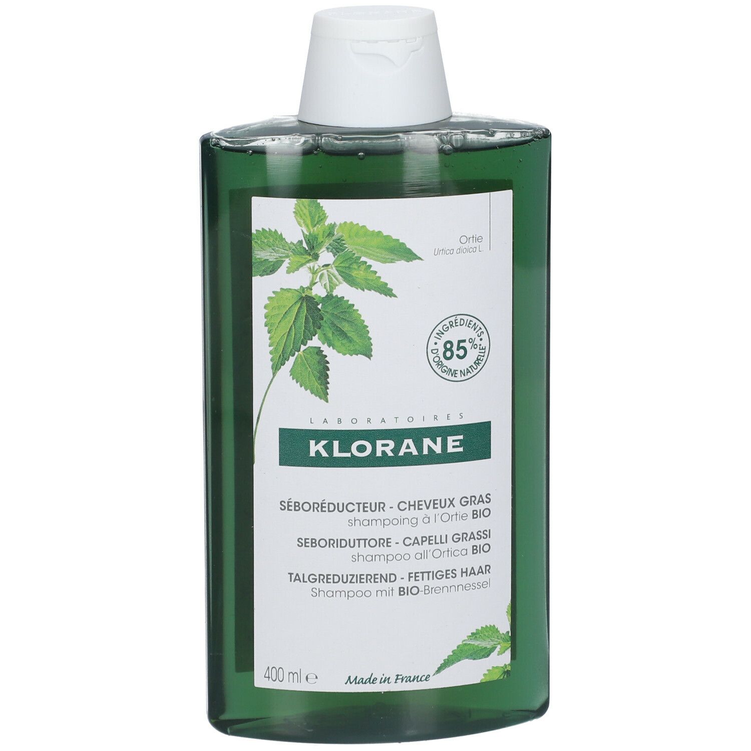 Grüne Shampoo-Flasche mit weißem Deckel. Aufschrift: KLORANE, SÉBORÉDUCTEUR, 85% natürliche Inhaltsstoffe. Brennnessel-Blätter.