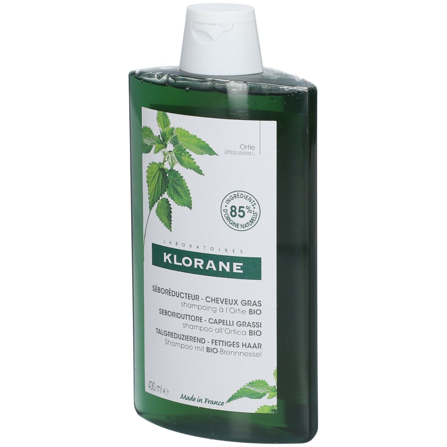 Grüne Shampoo-Flasche mit weißem Deckel. Aufschrift: KLORANE, SÉBORÉDUCTEUR, 85% natürliche Inhaltsstoffe. Brennnessel-Blätter.