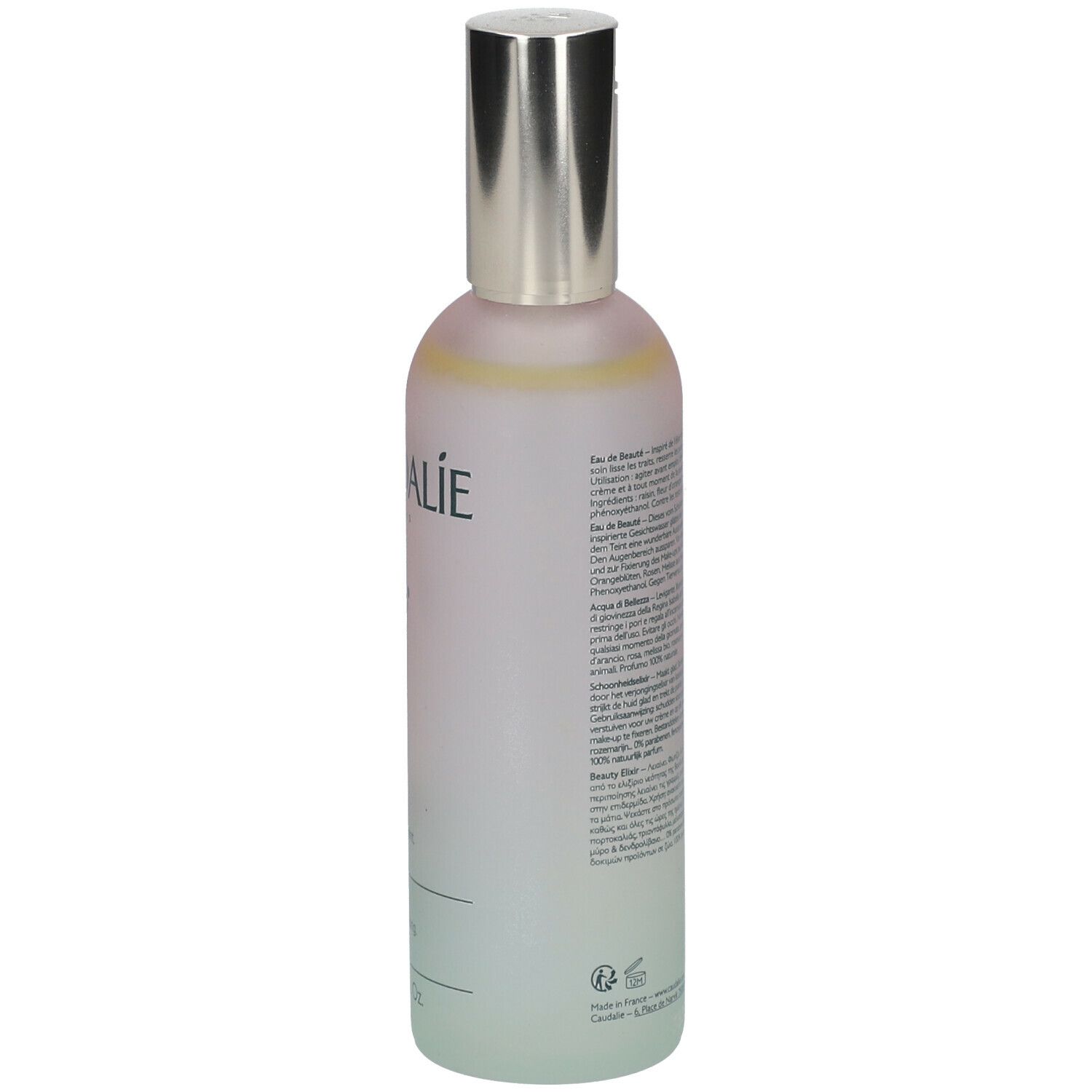 Flacone Caudalie Eau de Beauté. Retro con testo. Sfumatura rosa-verde, tappo argentato. Testo: Eau de Beauté.
