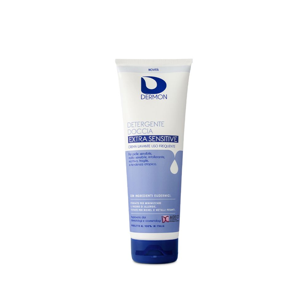 Tubo bianco-blu con testo. "Dermon Detergente Doccia Extra Sensitive" è visibile.
