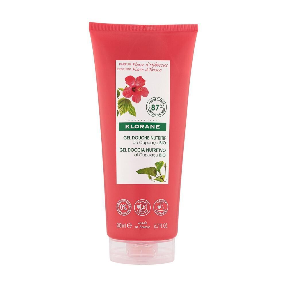 Tubo rosso con etichetta bianca. Scritta: KLORANE, Gel Douche Nutritif, Cupuaçu BIO. Illustrazione di fiori di ibisco.