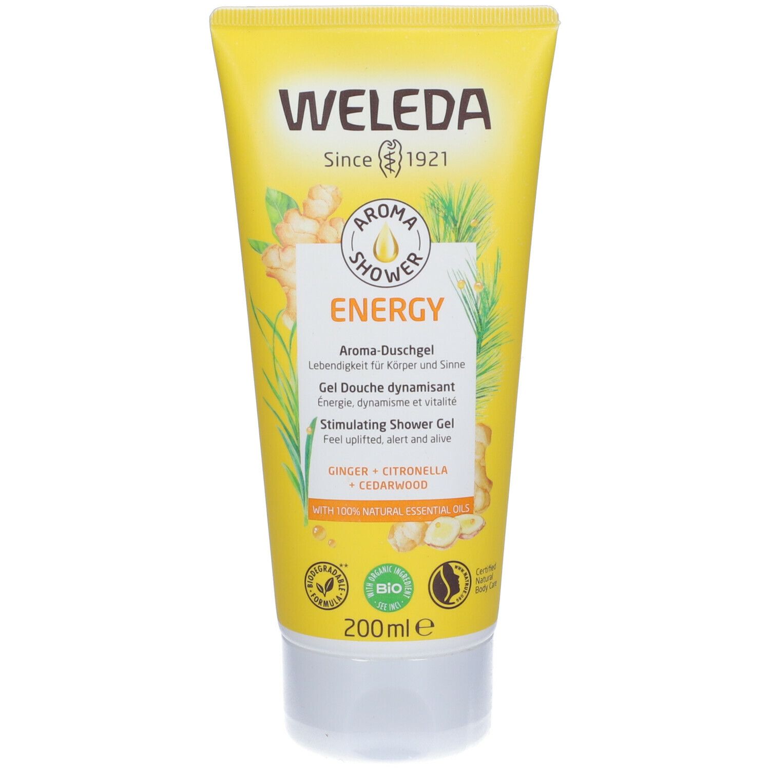 Tubo giallo con tappo bianco. Scritta WELEDA, Aroma Shower Energy. Contiene zenzero, citronella e legno di cedro. Certificazione bio.