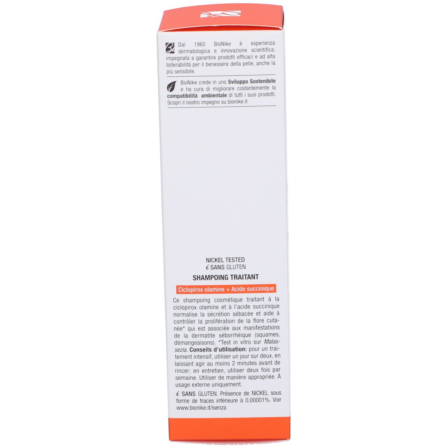 Lato della scatola con testo. Contiene informazioni sul trattamento shampoo, ingredienti e utilizzo. Accento arancione.